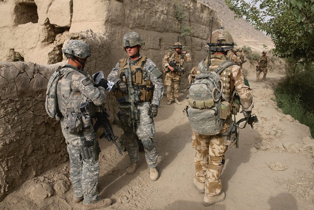 Amerikaanse militairen en medewerkers van DynCorp trainen Afghaanse militairen die papaverplantages moeten oprollen (2006).