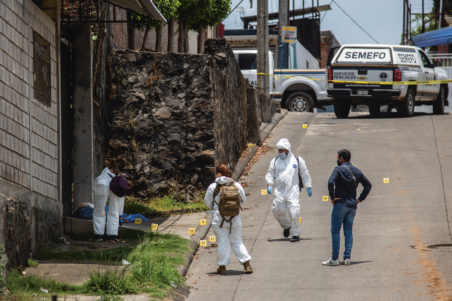 Een forensisch team onderzoekt een plaats delict vlak bij een avocadoveld in de straten van Uruapan. Deze stad heeft een van de hoogste moordcijfers ter wereld.