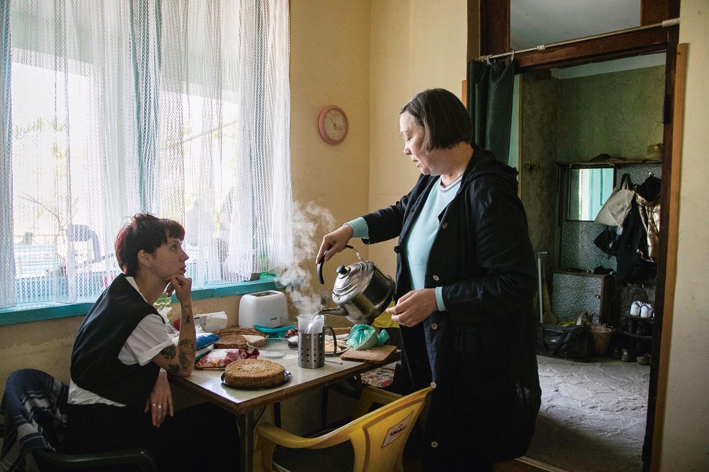 In de keuken van Olga. Gasimova (rechts). Vrijwilliger Kate Golubeva heeft de taart in stukken gesneden.